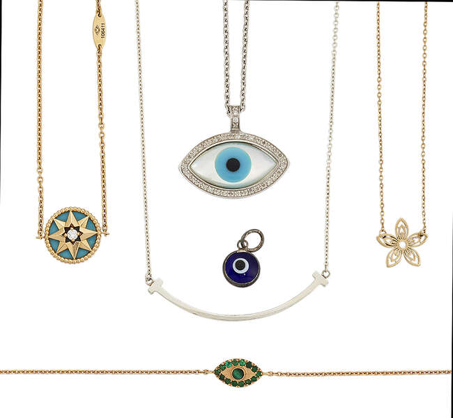 
	
		A group of jewellery comprising: a Tiffany &#39;T-smile&#39; necklace, two evil eye pendants and...