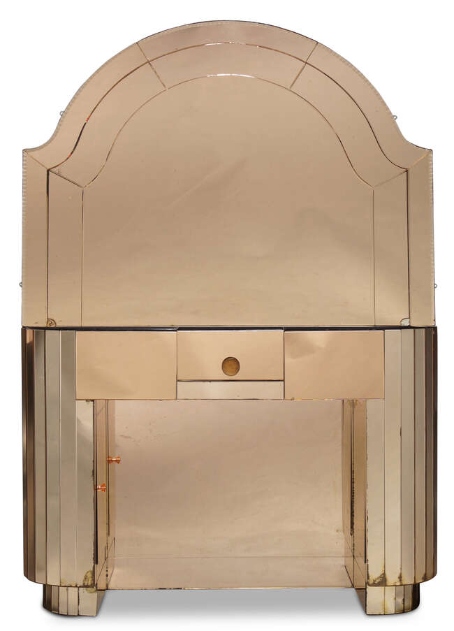 
	
		English Art Deco, a peach mirror-glass dressing table and mirror    
		c.1930    
		The...
