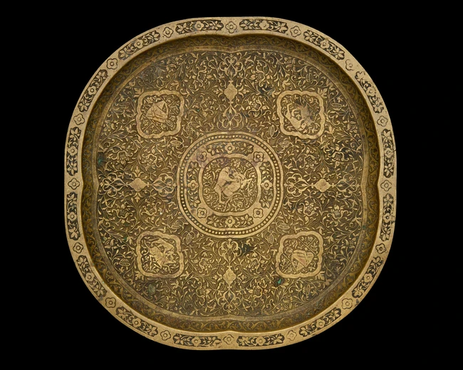 An engraved copper alloy lobed tray, Iran, 19th century or later, 
the central lobed medallion...
