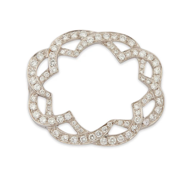 A diamond set component, composed of two interlocking sinuous lines, set with brilliant-cut...