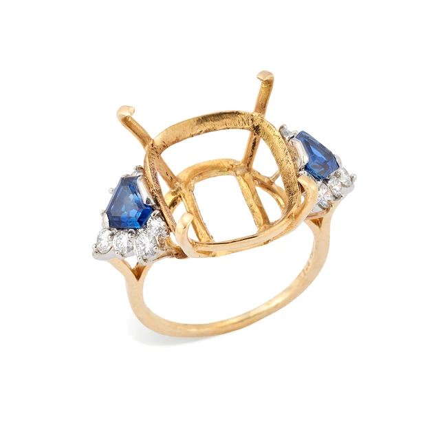 A sapphire and diamond set ring mount, composed of a cushion-shaped vacant collet, with...