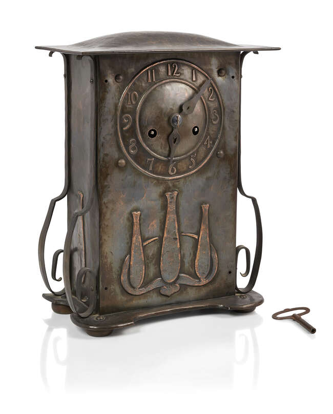 
	
		An Arts & Crafts patinated copper and oak mantel clock 
		c.1905 
		The rectangular...