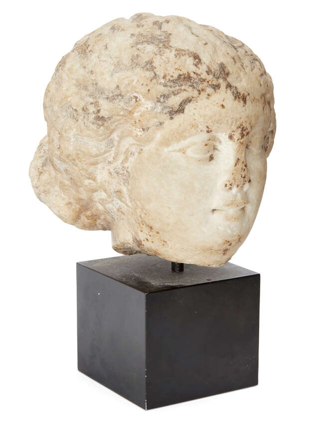 
	
		A marble female head
		After the Antique
		Her hair swept back from her forehead in...