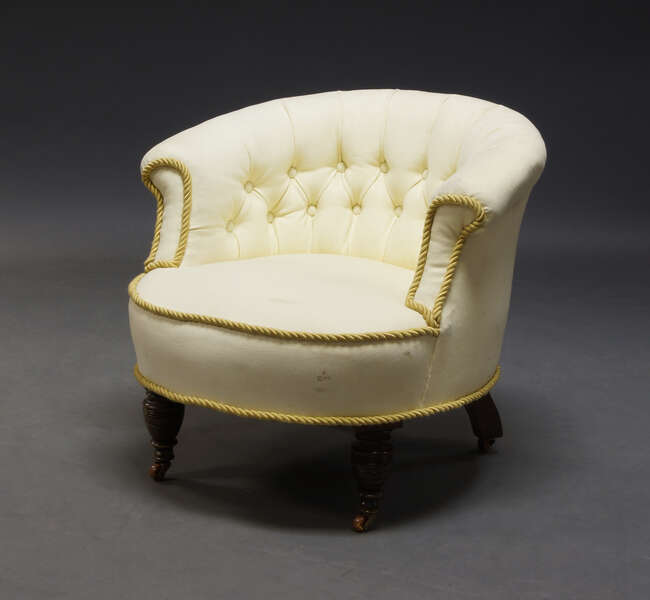 
	
		A Victorian button back tub chair, upholstered in cream fabric, with rope twist trim,...