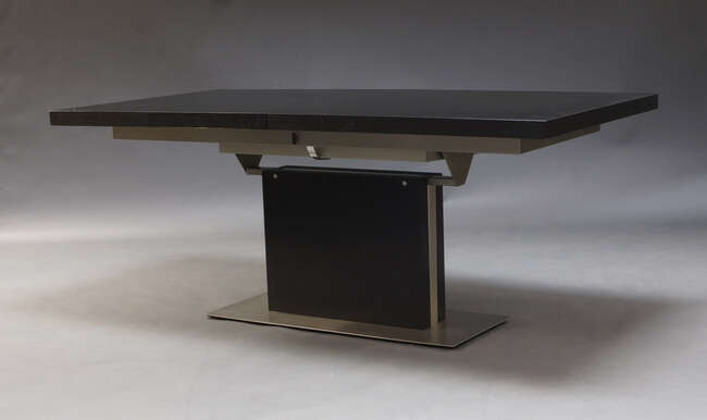 
	
		A contemporary extending dining table by BoConcept, the ebonised top with foldout...