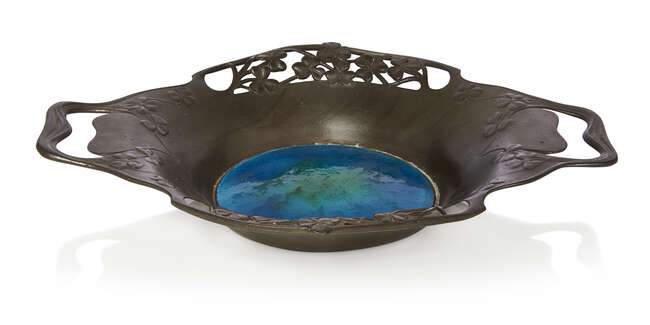 
	
		Liberty & Co (British), a pewter bowl with enamelled centre   
		c.1905, stamped Made in...