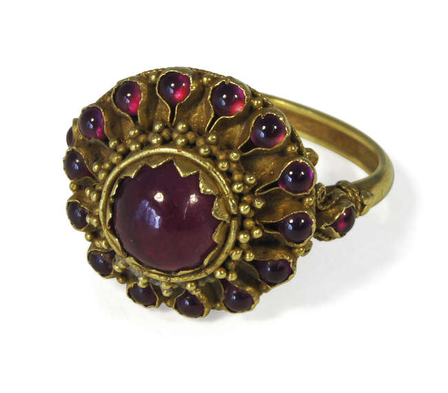 
	
		A Thai gold target ring, late 19th century, with ruby coloured paste stones in floral...