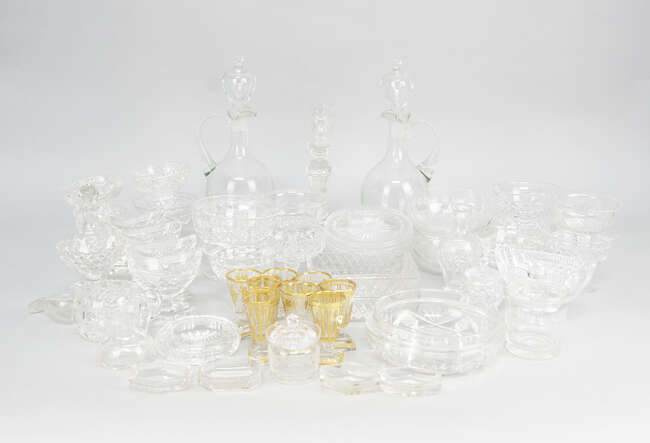 
	
		Two sets of four shot glasses, 20th century, decorated with gilt lining of grapes,...