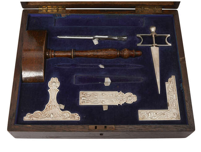 
	
		A Masonic working tools presentation box, early 20th century, to include: wood gavel,...