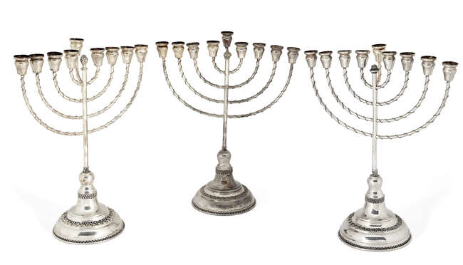 
	
		A pair of silver menorahs, by Hazorfim, stamped 925, each raised on a stepped circular...
