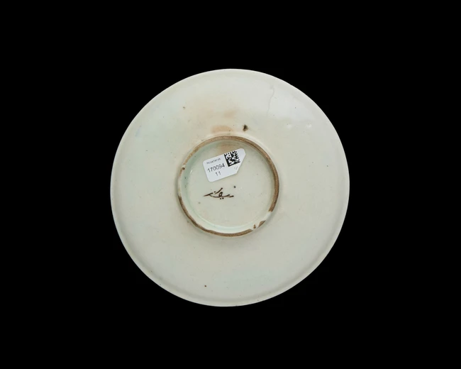 A Kutahya ware pottery saucer, Ottoman Turkey, 19th century, 
with a large aubergine floral...