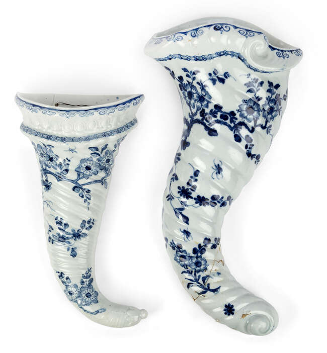 
	
		Two Worcester porcelain blue and white wall pockets, c.1755-65, blue crossed swords mark...