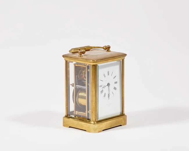 A French brass cased carriage clock, 20th century, with white enamel Roman dial inscribed 'W. H....
