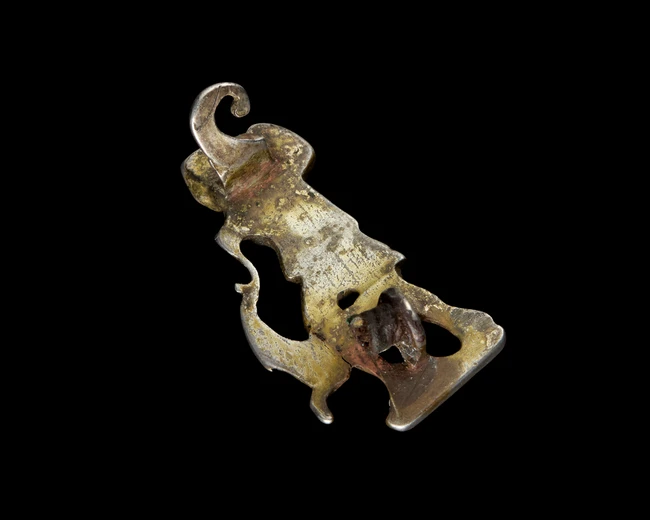 A silver-gilt fibula of Diana the huntress and a leaping deer,Possibly Roman, with signs of...