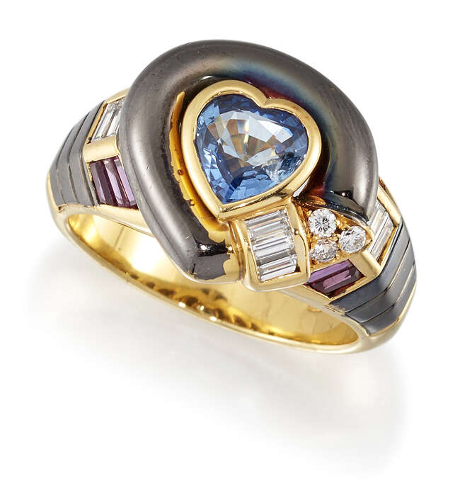 
	
		A sapphire, ruby and diamond ring, the central heart shaped sapphire collet within a...