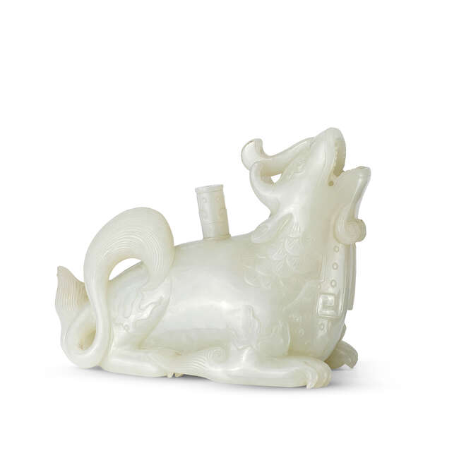 
	
		A Chinese white jade mythical beast pouring vessel, 18th/19th century, the mythical beast...