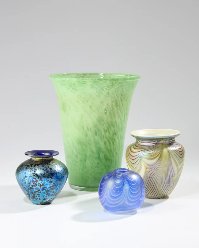 Studio glass Four studio glass vases comprising a Nazing green tapered vase, a Sanders &...