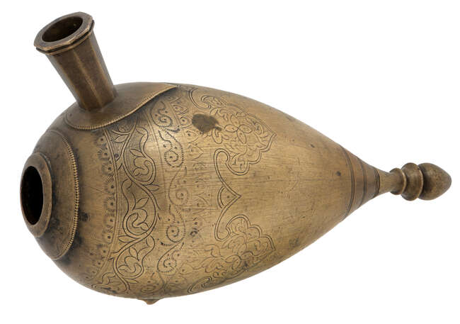 
	
		An engraved brass huqqa, India, 18th century, the bulbous body tapering towards a bud...