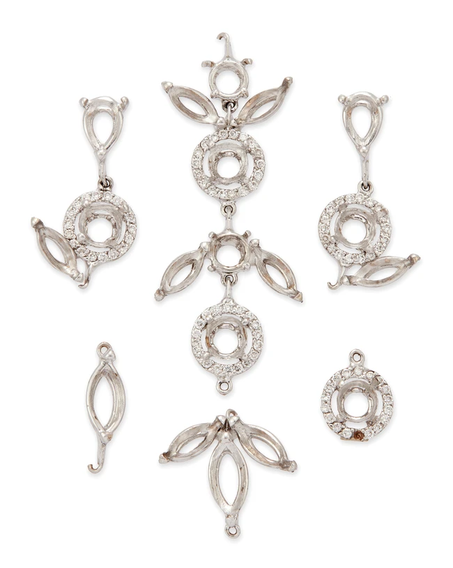 A group of vacant collets, comprising vacant marquise-shaped collets and round collets within...