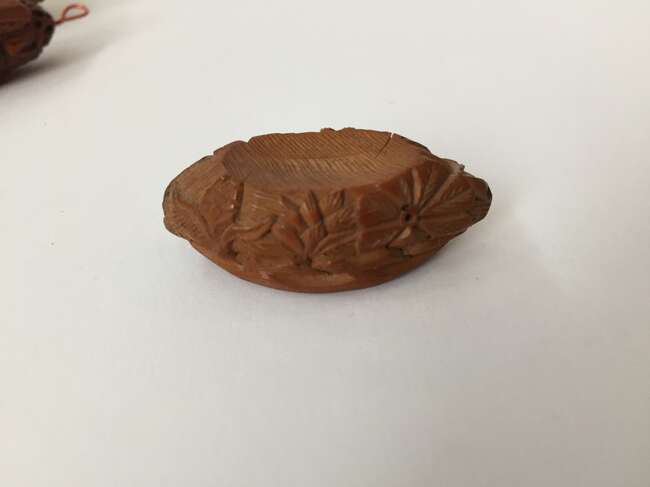 
	
		A Chinese hediao nut and stand, early 20th century, carved as a boat and inscribed to the...