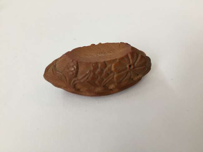 
	
		A Chinese hediao nut and stand, early 20th century, carved as a boat and inscribed to the...