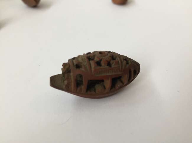 
	
		A Chinese hediao nut and stand, early 20th century, carved as a boat and inscribed to the...
