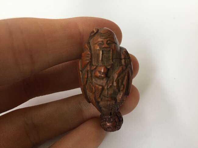 
	
		A Chinese hediao nut and stand, early 20th century, carved as a boat and inscribed to the...