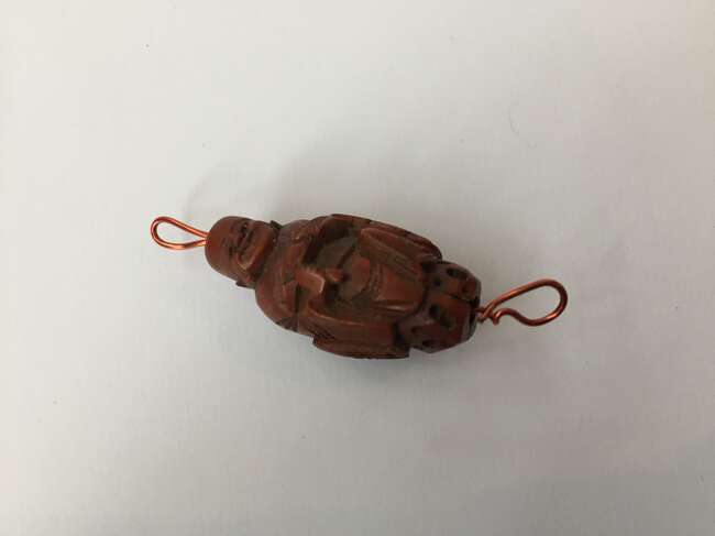 
	
		A Chinese hediao nut and stand, early 20th century, carved as a boat and inscribed to the...