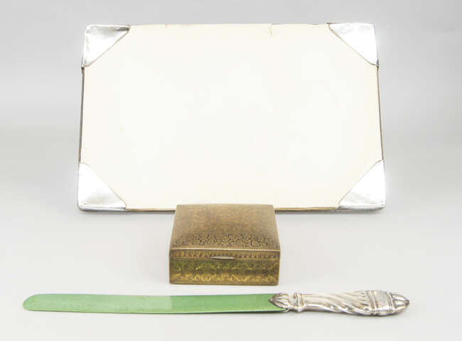 
	
		A silver-mounted, green stained ivory page turner, London c.1901, the silver handle of...