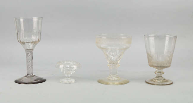
	
		A tall wine glass, 18th century, with bucket form bowl decorated to the base with writhen...
