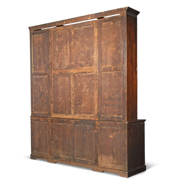 
	
		A George III mahogany breakfront bookcase, late 18th century, the fluted cornice above...
