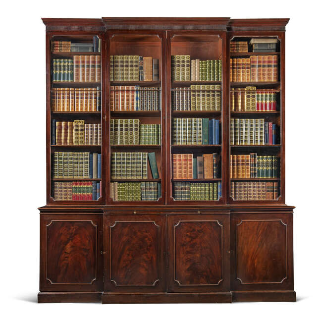 
	
		A George III mahogany breakfront bookcase, late 18th century, the fluted cornice above...