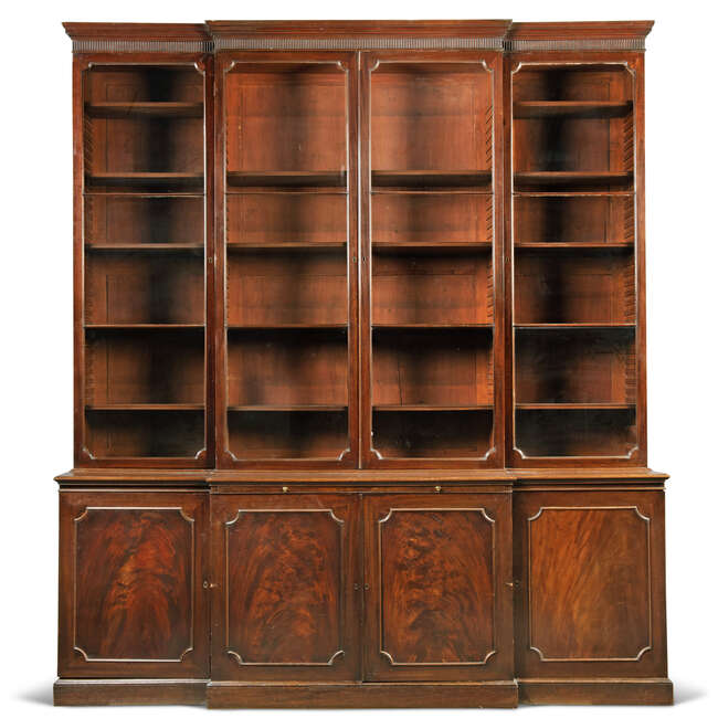 
	
		A George III mahogany breakfront bookcase, late 18th century, the fluted cornice above...