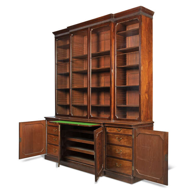 
	
		A George III mahogany breakfront bookcase, late 18th century, the fluted cornice above...