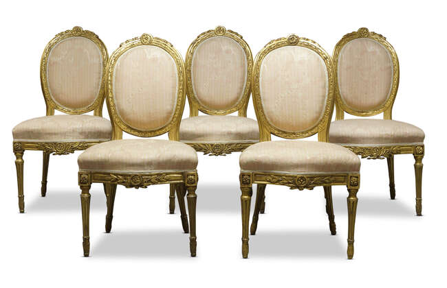 
	
		A set of five Louis XVI giltwood salon chairs, late 18th Century, the crest centred by...