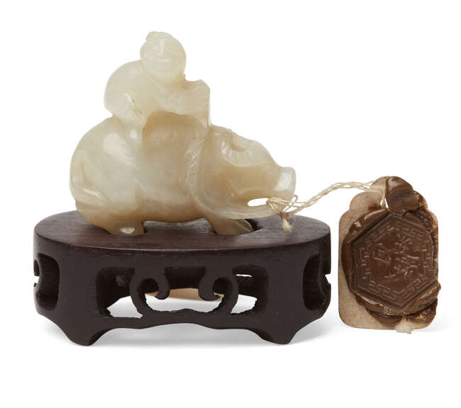 
	
		A Chinese pale green jade figure of a buffalo, late Qing dynasty, carved as a boy riding...