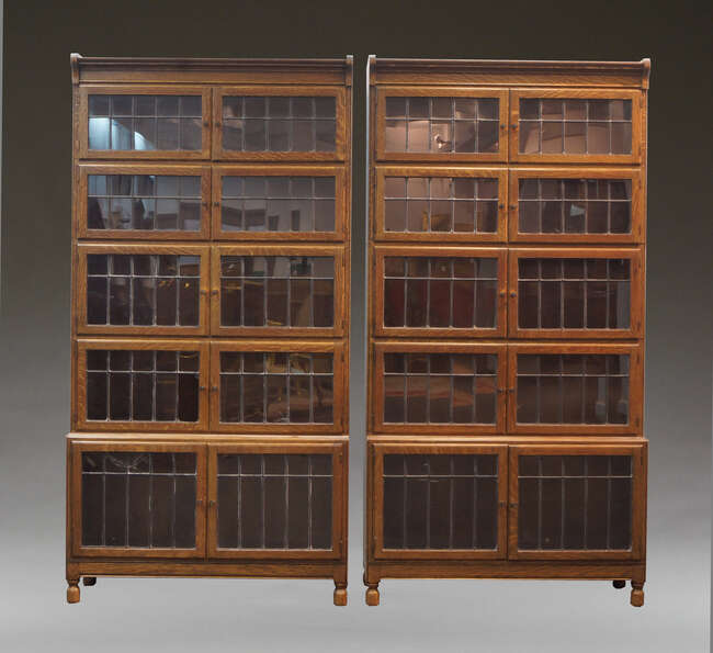 
	
		A pair of Minty oak and glazed five-section stacking bookcases, early 20th Century, each...