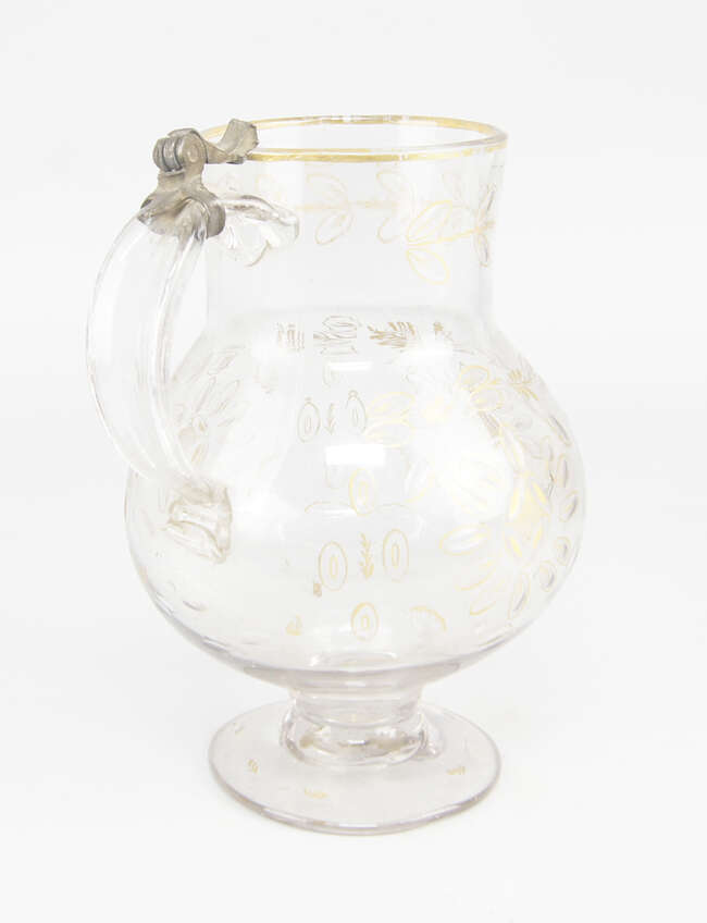 
	
		A Continental glass flagon, late 18th/19th century, of bellied form with pedestal foot...