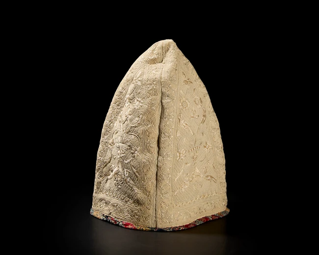 A silk satin stitch and running stitch embroidered and quilted cotton conical hat, Qajar Iran,...