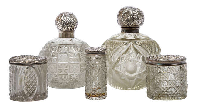 
	
		Five silver mounted cut glass vessels, comprising two globular bottles with glass...