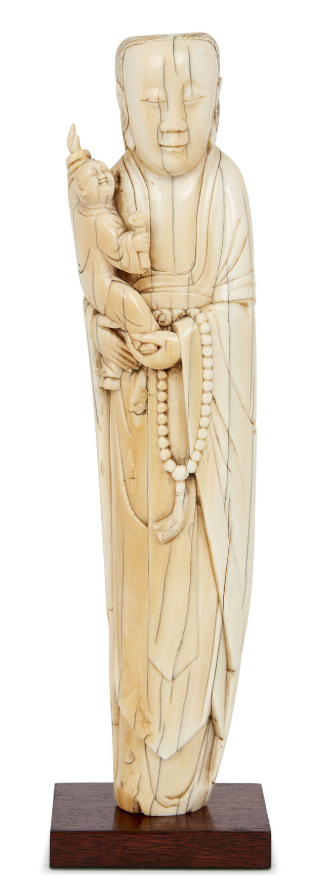 
	
		A Chinese ivory figure of Guanyin, late Ming dynasty, carved standing, holding a child...