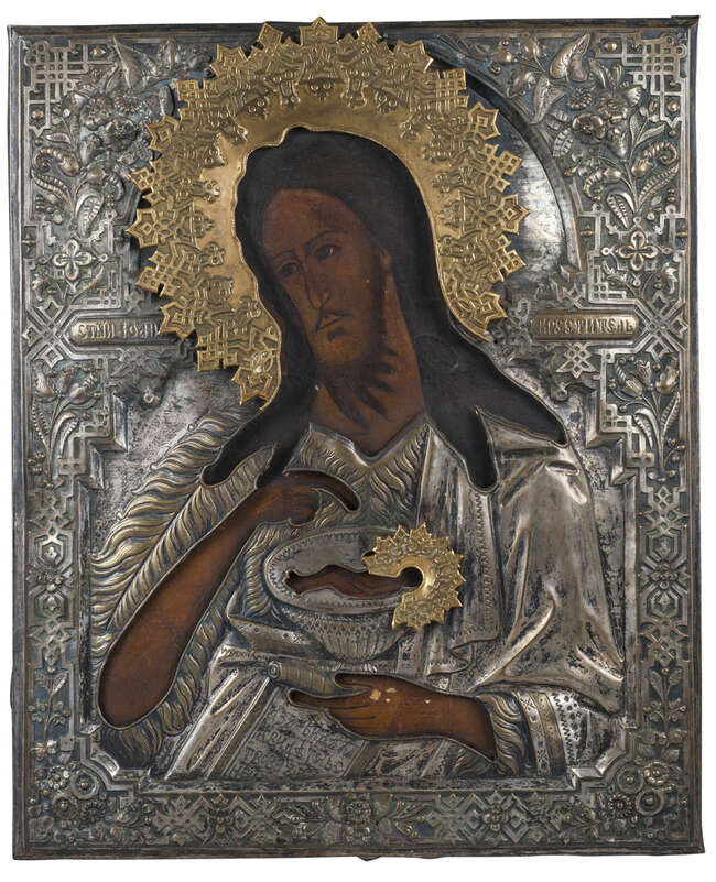 
	
		A Russian icon of St John the Baptist, mid 19th Century, with chased silver oklad,...
