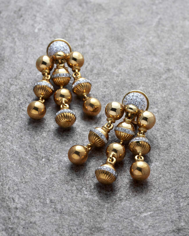 
	
		A pair of diamond ball drop chandelier earrings, the rounded pave diamond tops to three...