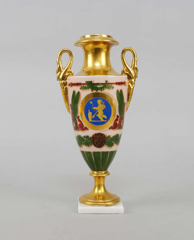 
	
		A French porcelain Empire style vase, late 19th century, with swan neck handles, on a...