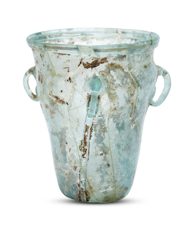 
	
		A Byzantine pale bluish-green glass hanging lamp, 6th-7th century, with three loop...