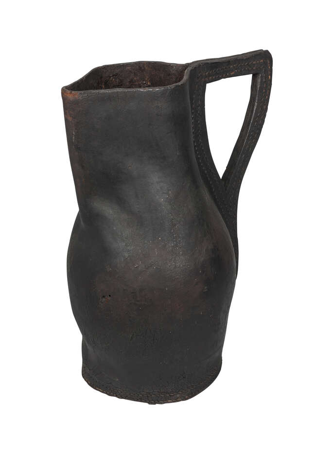 
	
		An English leather black jack, 19th century, of typical form, with angular handle,...