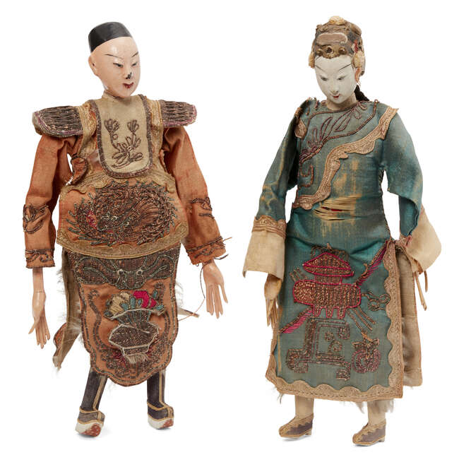 
	
		Two Chinese dolls, late 19th century, with painted wood heads and limbs, one wearing a...