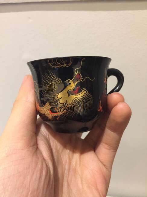 
	
		A Chinese painted lacquer coffee set, 20th century, comprised of eight cups and saucers...