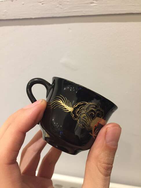 
	
		A Chinese painted lacquer coffee set, 20th century, comprised of eight cups and saucers...