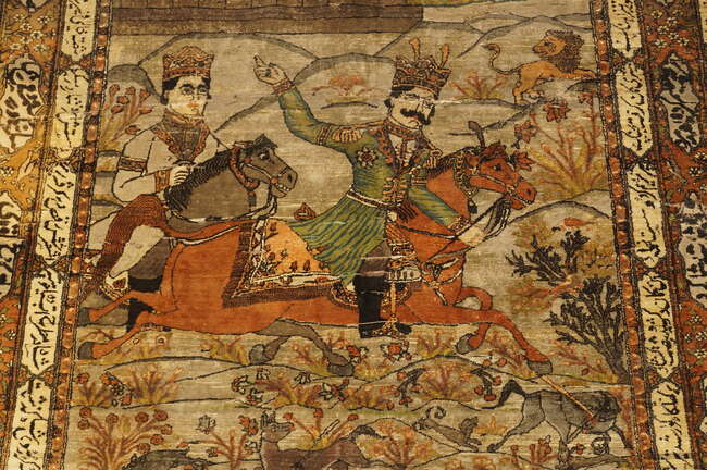 A pair of Persian Kashan silk pictorial rugs, late 19th/early 20th century, woven with nobleman...